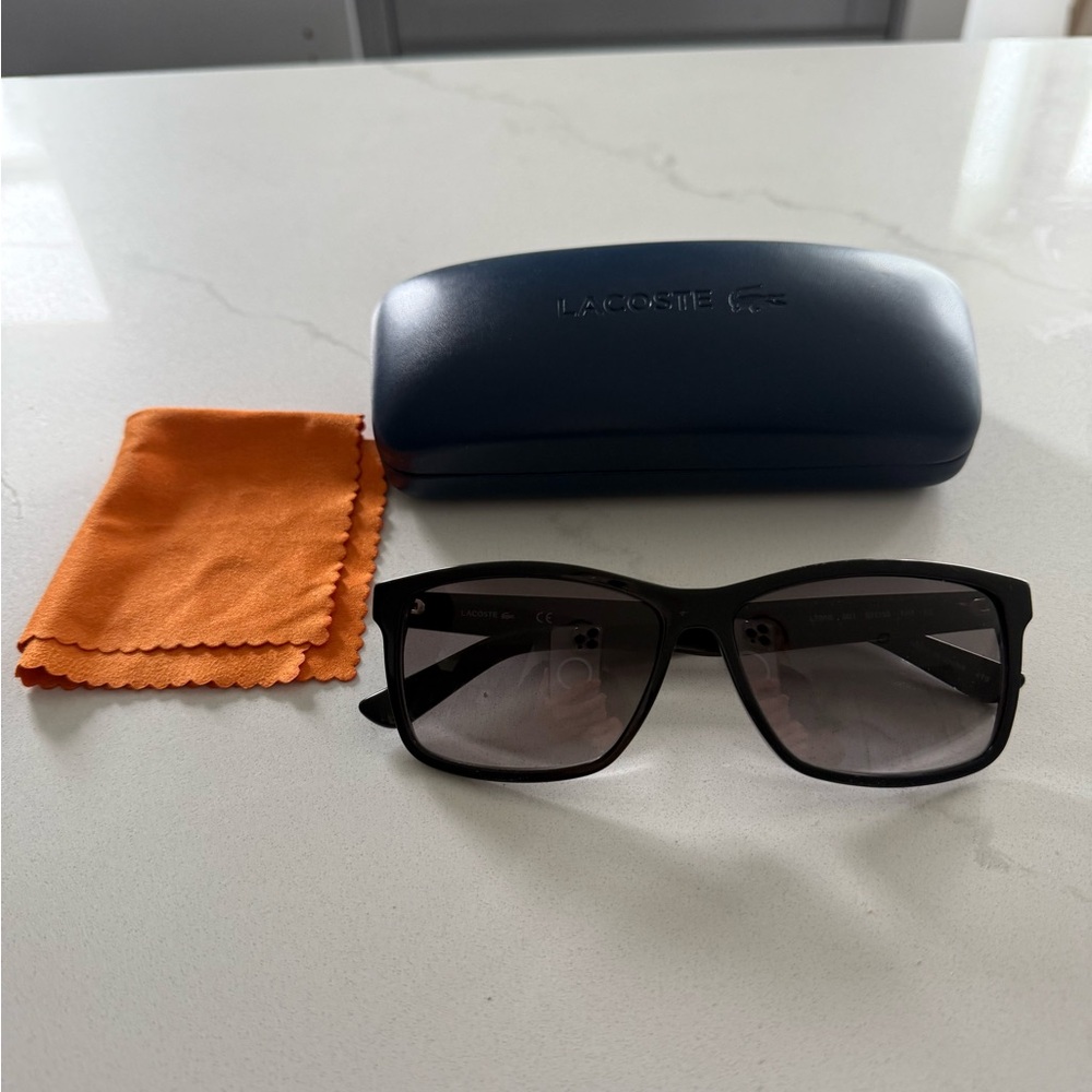 Black Lacoste L705S sunglasses with hard case and cloth